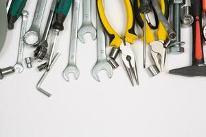 Set of tools for repair in a case on a white background. Assorted work or construction tools. Wrenches, Pliers, screwdriver. Top view photo