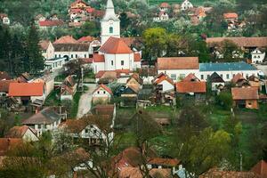 Rimetea is a small village located in Transylvania, Romania. It is situated in the Apuseni Mountains and is known for its picturesque setting and well preserved Hungarian architectural style. photo