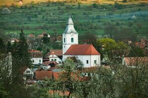 Rimetea is a small village located in Transylvania, Romania. It is situated in the Apuseni Mountains and is known for its picturesque setting and well preserved Hungarian architectural style. photo