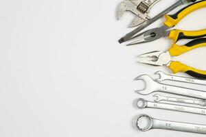 Set of tools for repair in a case on a white background. Assorted work or construction tools. Wrenches, Pliers, screwdriver. Top view photo