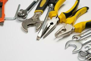 Set of tools for repair in a case on a white background. Assorted work or construction tools. Wrenches, Pliers, screwdriver. Top view photo