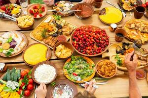 Homemade Romanian Food with grilled meat, polenta and vegetables Platter on camping. Romantic traditional moldavian food outside on the wood table. photo