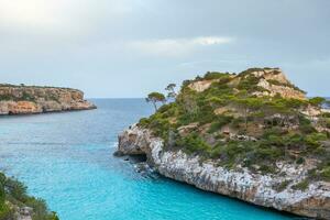 Calo des Moro, Majorca, Spain. Beautiful beach landscape, exotic tropical island nature, blue sea water, ocean waves, summer holidays vacation. photo