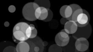 abstrakt vit glitter och partikel på svart bakgrund. looped animering med skön vit bokeh på svart bakgrund. video