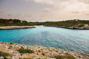 Beautiful sunset beach landscape, exotic tropical island nature, blue sea water, ocean waves, summer holidays vacation in Mallorca, Spain photo