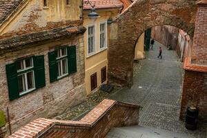 Medieval street with historical buildings in the heart of Romania. Sibiu the eastern European citadel city. Travel in Europe photo