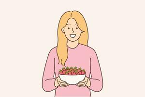 Woman holds plate of strawberries and smiles, offers to try fresh berries and farm fruits. Girl with smile looks at screen recommending eating organic strawberries containing antioxidants vector