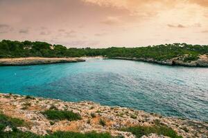 Beautiful sunset beach landscape, exotic tropical island nature, blue sea water, ocean waves, colorful red yellow sky, summer holidays vacation in Mallorca, Spain photo