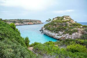 Calo des Moro, Majorca, Spain. Beautiful beach landscape, exotic tropical island nature, blue sea water, ocean waves, summer holidays vacation. photo