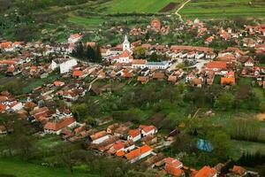 Rimetea is a small village located in Transylvania, Romania. It is situated in the Apuseni Mountains and is known for its picturesque setting and well preserved Hungarian architectural style. photo