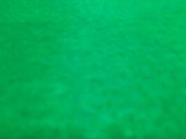 Defocused abstract carpet background in bright green color photo