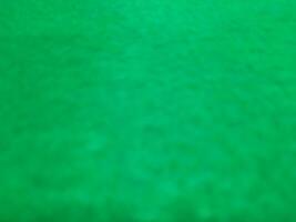 Defocused abstract carpet background in bright green color photo