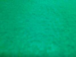 Defocused abstract carpet background in bright Tosca green color photo