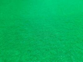Defocused abstract carpet background in bright green color photo