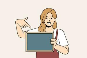 Woman waiter is holding chalkboard with copy space for drawing menu cafe or restaurant photo