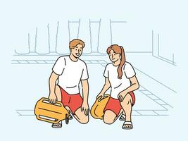 Pair of lifeguards sit by pool at hotel, holding swim training aids and keeping visitors safe photo