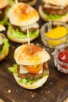 Ready to serve mini hamburgers. Step by step preparation of mini burgers. Homemade mini burgers for children or appetizers. Small hamburgers. photo