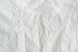 Wrinkled or crumpled white stencil paper or tissue after use in toilet or restroom with large copy space used for background texture in decorative art work. photo