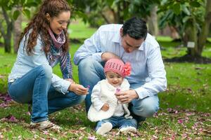 Family of three having fun outdoors in a beautiful sunny day at the park. Happiness concept. Family concept. photo