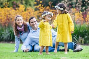 Family of four having fun outdoors in a beautiful sunny day at the park. Happiness concept. Family concept. photo