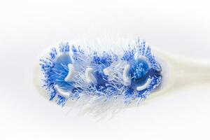 Closeup of an old toothbrush on white background. Oral health concept photo