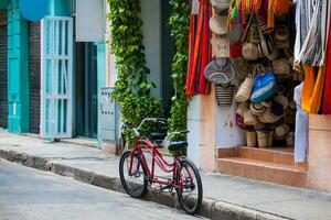 Bicycle parked at the beautiful streets of the walled city in Cartagena de Indias. Urban bicycle concept. Mobility concept photo