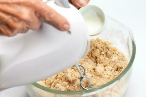 Ravioli Preparation. Pasta dough preparation. Adding milk photo