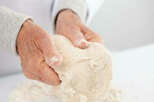 kneading by hand. Home made pizza dough preparation. Pizza preparation. photo