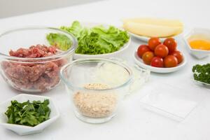 Ingredients for burger. Step by step preparation of mini burgers. Homemade mini burgers for children or appetizers. Small hamburgers. photo