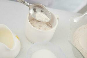 Leaven yeast. Yeast preparation for pizza dough. Adding flour. Home made pizza dough preparation. Pizza preparation. photo