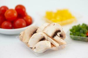 Mushrooms  and other vegetables pizza topping ingredients. Pizza preparation. photo