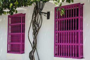 Beautiful colonial street of Cartagena de Indias. Facade of a house in Cartagena de Indias. Colorful windows photo