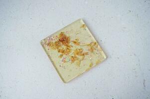Handmade resin coaster with floral pattern on white background. Selective focus. photo