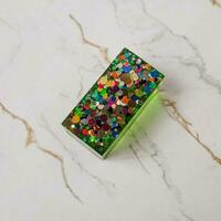 Handmade resin coaster with floral pattern on white background. Selective focus. photo