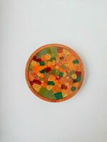 Handmade resin coaster with floral pattern on white background. Selective focus. photo