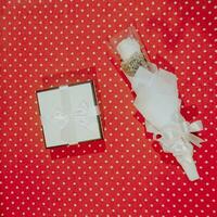 Gift box with ribbon and bow on red polka dot background photo