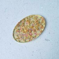 Handmade resin coaster with floral pattern on white background. Selective focus. photo
