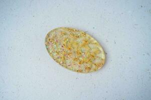 Handmade resin coaster with floral pattern on white background. Selective focus. photo