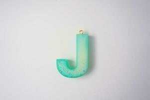 Letter J of the English alphabet made of colored plasticine on a white background photo