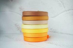 colorful ribbons stacked on a grey marbled background. Ribbon for handmade craft DIY photo