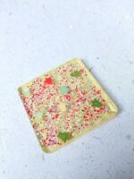 Handmade resin coaster with floral pattern on white background. Selective focus. photo