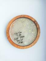 Handmade resin coaster with floral pattern on white background. Selective focus. photo