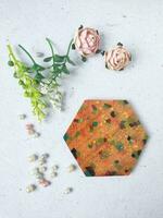 Handmade resin coaster with floral pattern on white background. Selective focus. photo