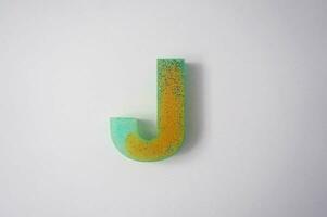 Letter J of the English alphabet made of colored plasticine on a white background photo