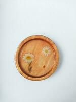 Handmade resin coaster with floral pattern on white background. Selective focus. photo