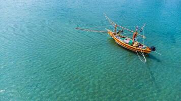 A small fishing boat floating in the sea photo