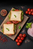 Delicious sandwich with toast, ham, tomatoes, cheese and lettuce photo