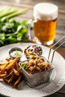 Fried chicken nuggets with french fries, dip, salad and beer photo