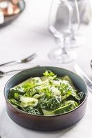 Vegan salad from kohlrabi and spinach with parsley served in a bowl photo