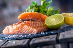 Raw salmon fillets with parsley herbs lime lemon salt and dried saffron photo